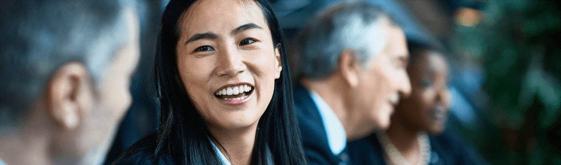 Southern Cross - A woman smiling during a meeting A woman smiling during a meeting